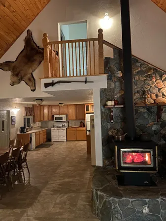 a living room with stainless steel appliances kitchen island furniture and a flat screen tv