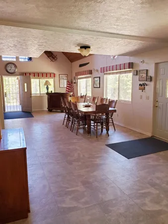a view of a dining room with furniture window and outside view
