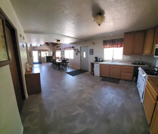 a large kitchen with a large counter top appliances and furniture