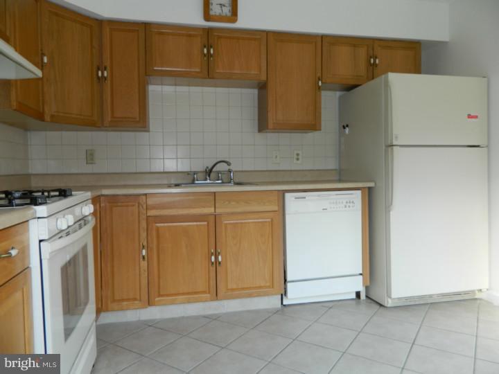 25 Blue Grass Road Clementon, NJ 08021 - Photo 5 of 25 a kitchen with a sink a stove and cabinets