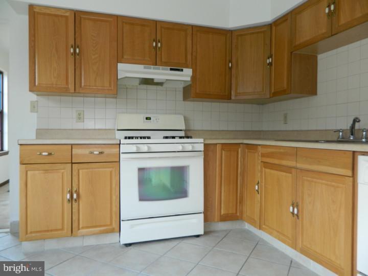 25 Blue Grass Road Clementon, NJ 08021 - Photo 6 of 25 a kitchen with granite countertop cabinets and white appliances