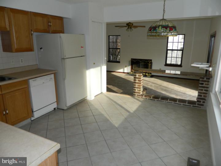 25 Blue Grass Road Clementon, NJ 08021 - Photo 8 of 25 a kitchen with a refrigerator and a stove top oven