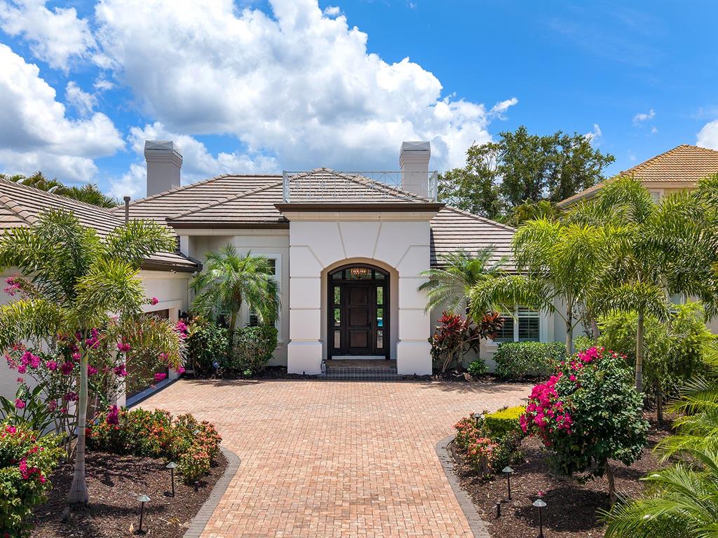 7431 Greystone Street Lakewood Ranch, FL 34202 - Photo 75 of 85 a front view of a house with a garden