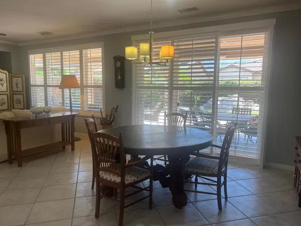 a view of a dining room with furniture and window