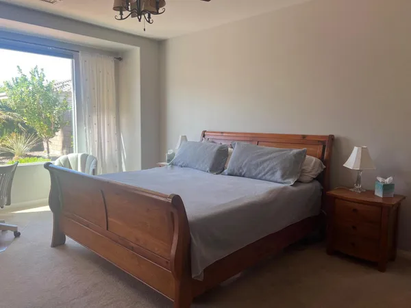 a bed sitting in a bedroom next to a window