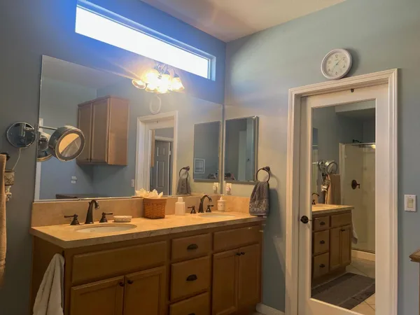 a bathroom with a double vanity sink and a mirror