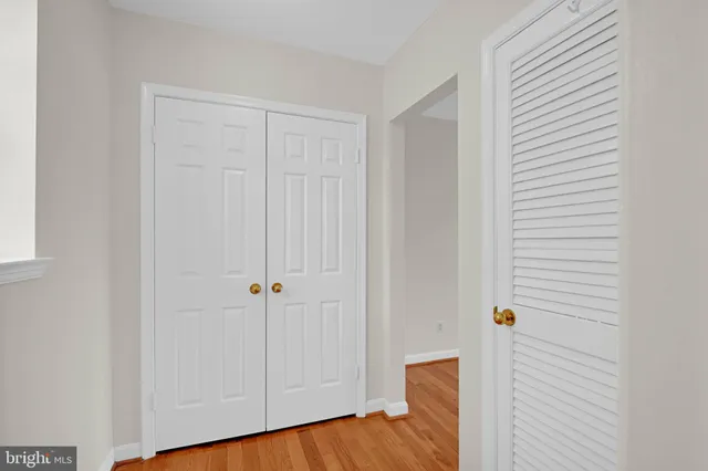 a view of a room with wooden floor