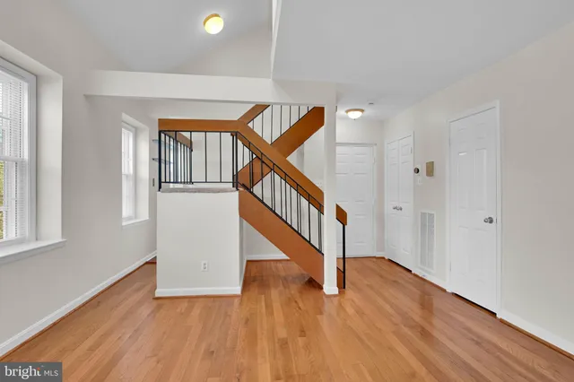 a view of entryway and hall with wooden floor