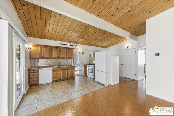 a large kitchen with a lot of cabinets and refrigerator