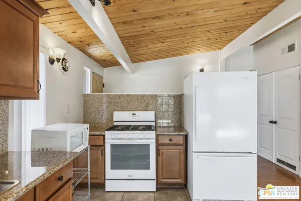 a kitchen with a refrigerator and a stove