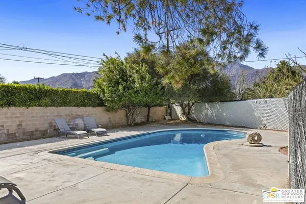 a view of a swimming pool with a patio