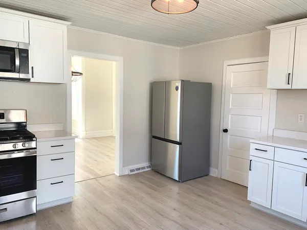 a kitchen with a refrigerator and a stove