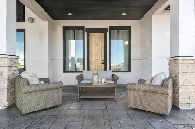 a kitchen with stainless steel appliances kitchen island granite countertop a refrigerator a stove a oven a dining table and chairs with wooden floor