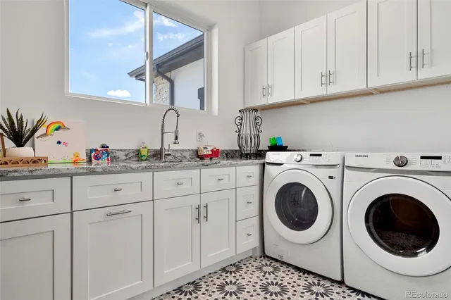 a kitchen with stainless steel appliances granite countertop a refrigerator a stove and a sink