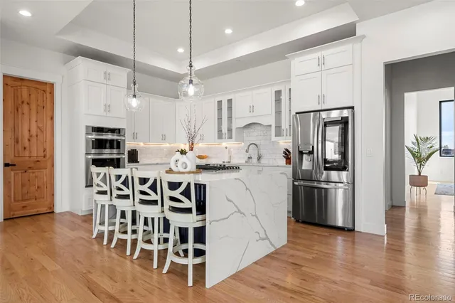 a living room with a couch and a fireplace with wooden floor