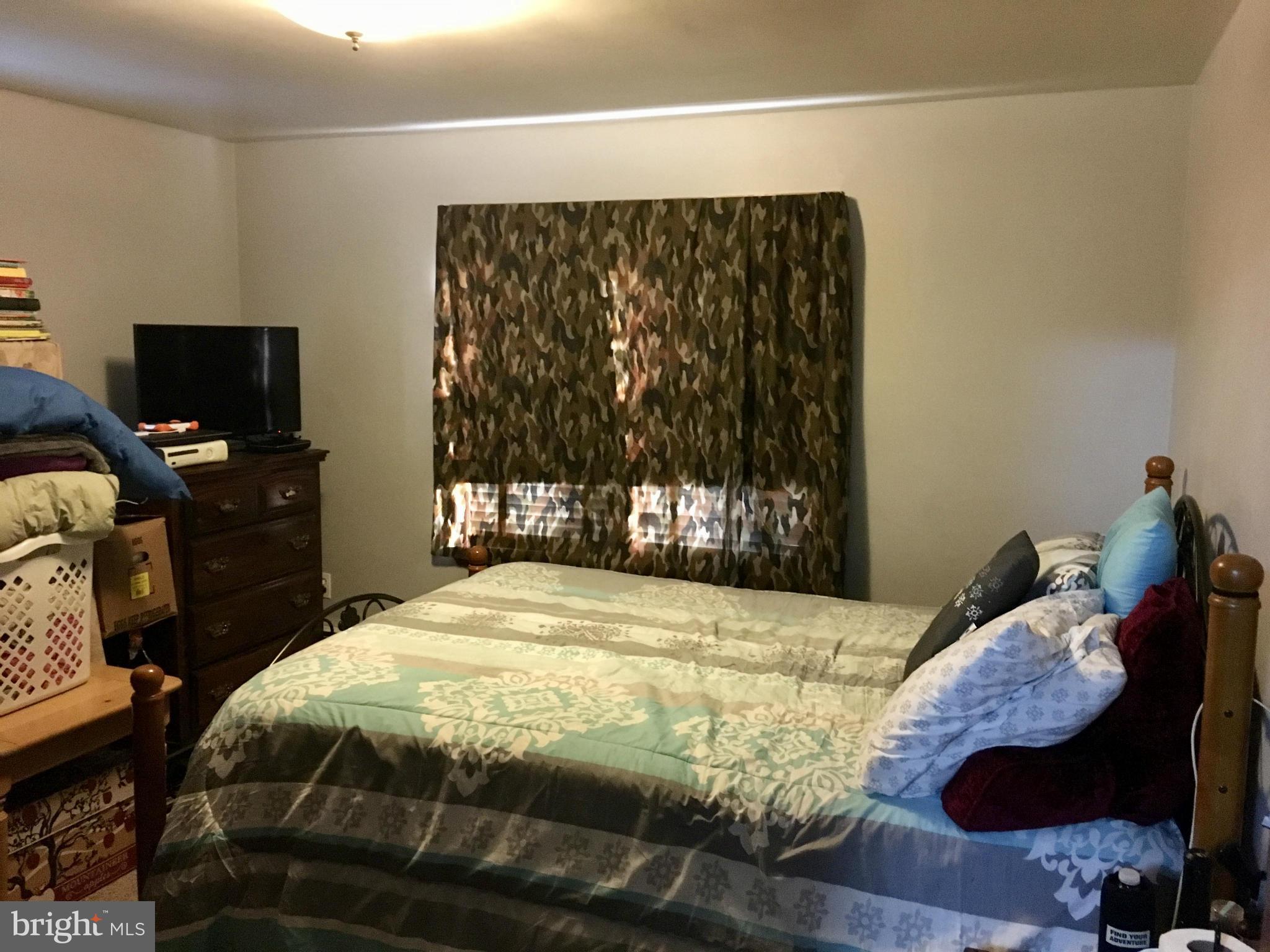 348 Nottingham Road Hagerstown, MD 21740 - Photo 6 of 8 a bed sitting in a bedroom next to a window with tv