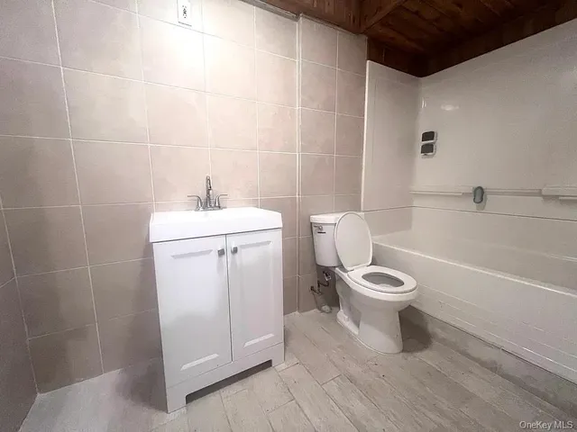 a white toilet sitting next to a bathroom sink