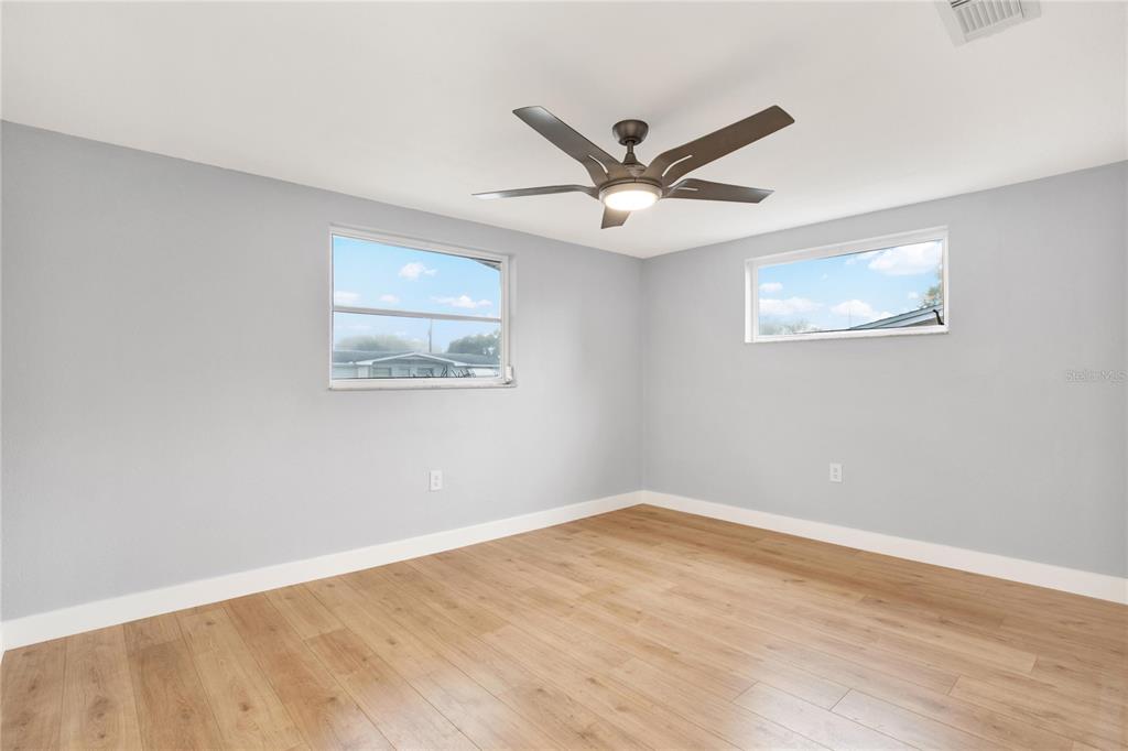 5200 Dove Drive New Port Richey, FL 34652 - Photo 5 of 8 a view of an empty room with wooden floor