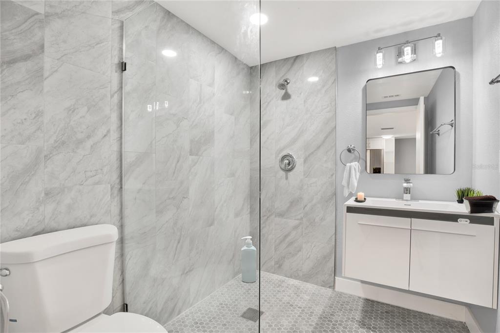 5200 Dove Drive New Port Richey, FL 34652 - Photo 7 of 8 a bathroom with a double vanity sink mirror and toilet