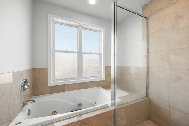 a bathroom with a bathtub and a shower