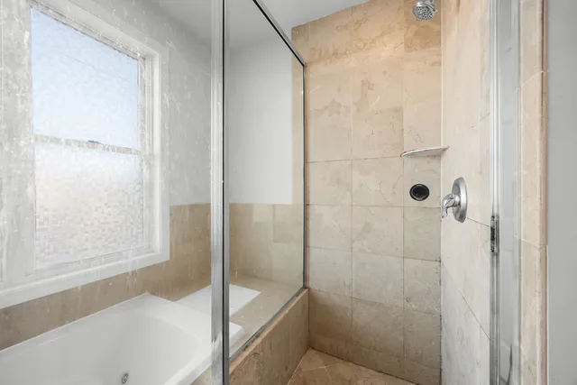 a bathroom with a bathtub and a shower