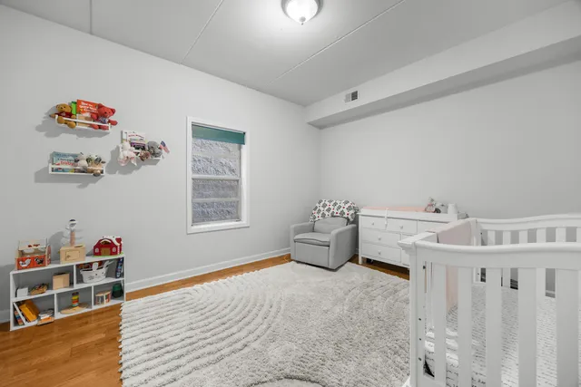 a spacious bedroom with a bed and a window