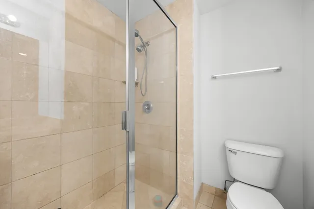 a white toilet sitting next to a bathroom sink