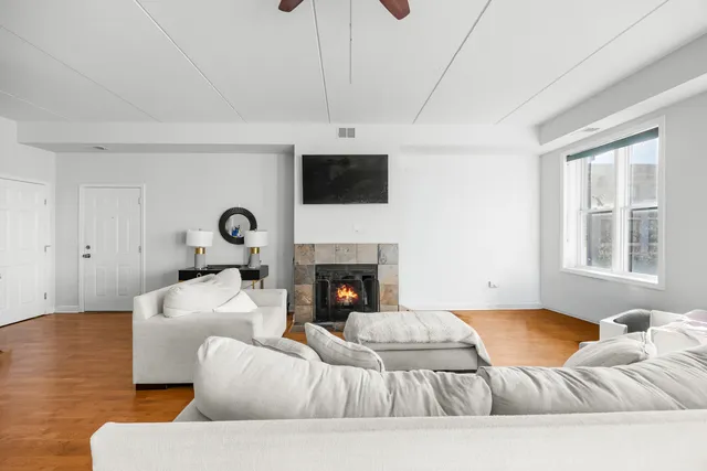 a living room with furniture a fireplace and a flat screen tv
