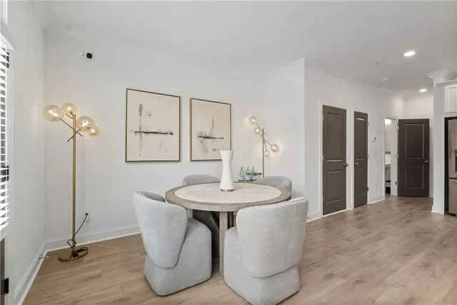 a dining room with furniture a mirror and wooden floor