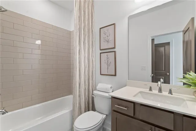 a bathroom with a sink toilet vanity and shower