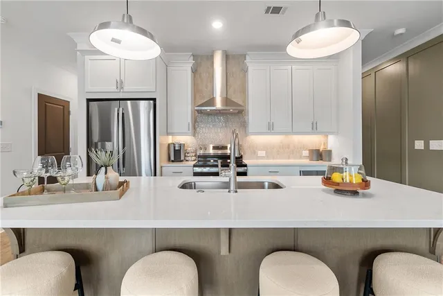 a kitchen with a refrigerator a sink and cabinets