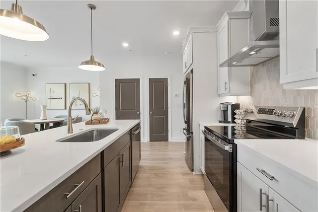 a kitchen with a sink stove and refrigerator