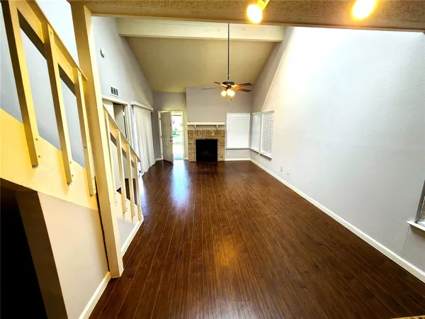 a view of a livingroom with wooden floor and fireplace