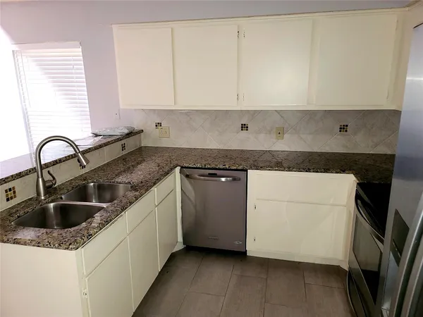 a kitchen with a sink and cabinets