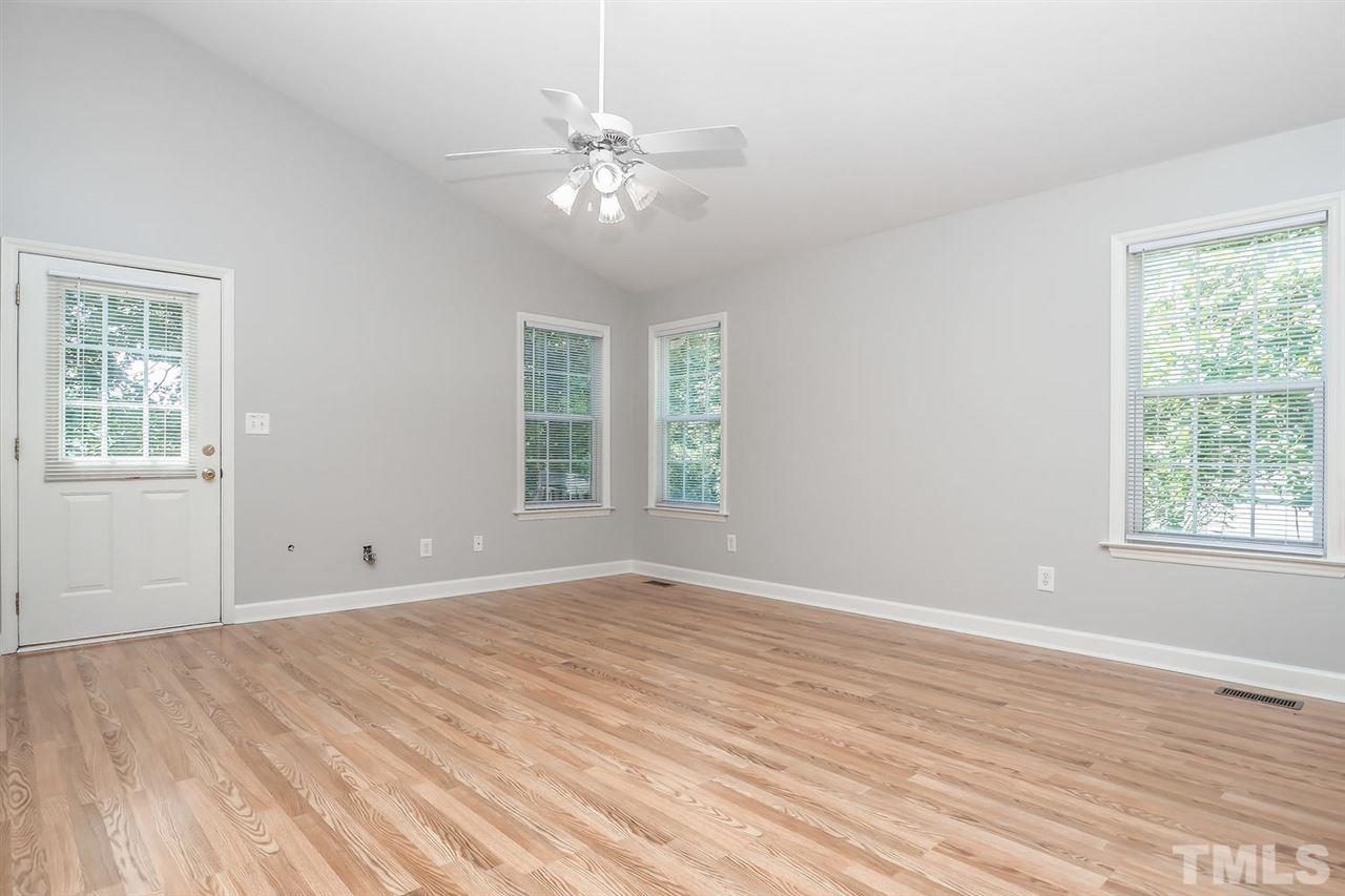 3121 Stedman Drive Raleigh, NC 27607 - Photo 2 of 25 a view of an empty room with wooden floor and a window