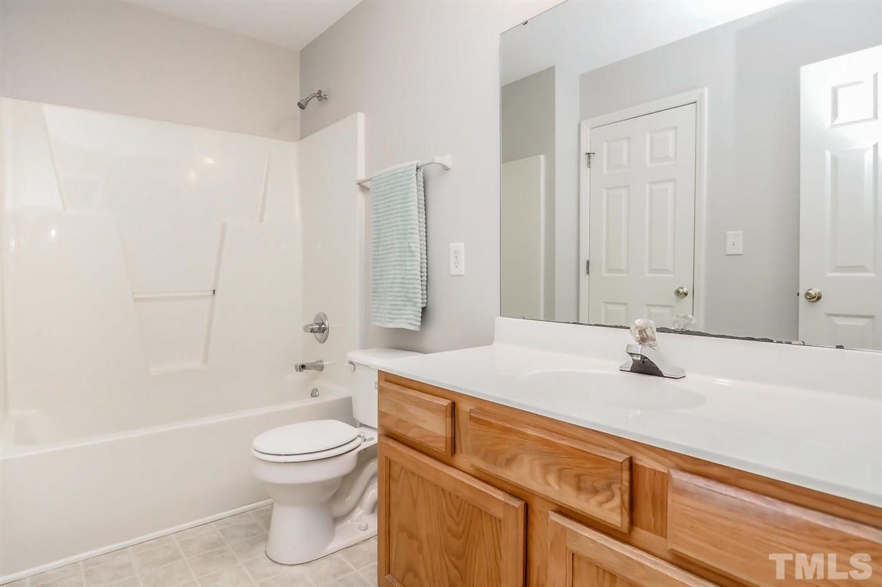 3121 Stedman Drive Raleigh, NC 27607 - Photo 15 of 25 a bathroom with a sink a toilet and a large mirror