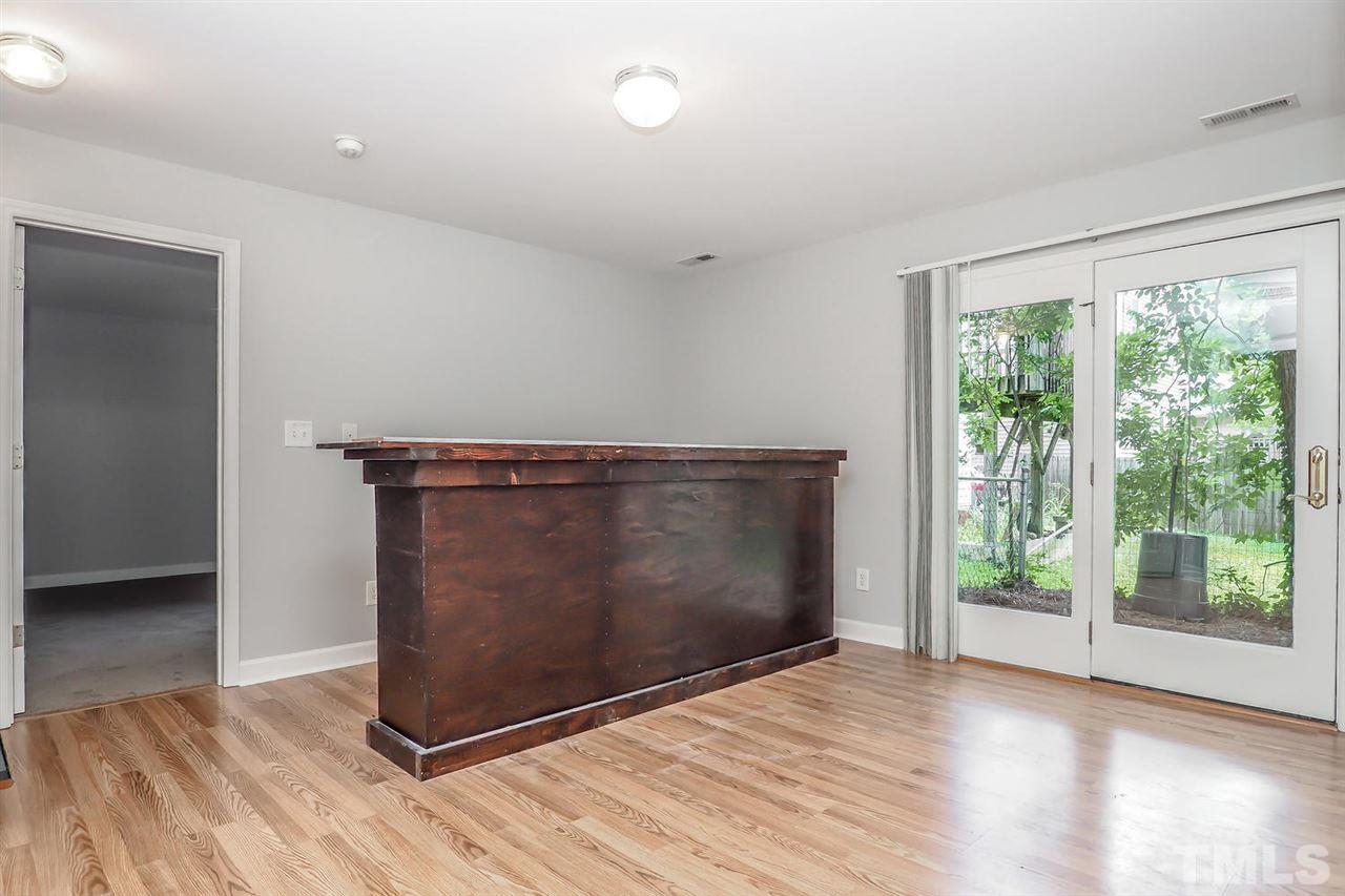 3121 Stedman Drive Raleigh, NC 27607 - Photo 18 of 25 an empty room with wooden floor and windows