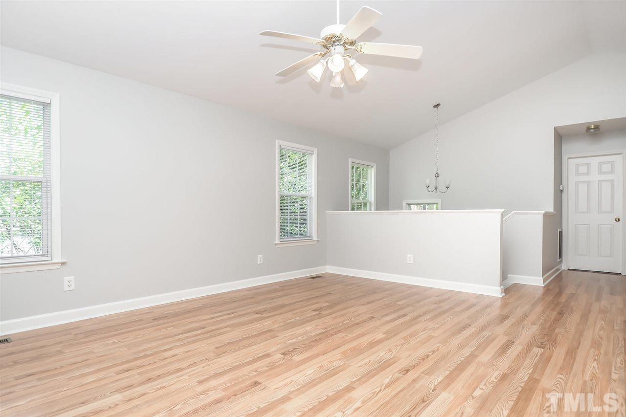 3121 Stedman Drive Raleigh, NC 27607 - Photo 4 of 25 wooden floor in an empty room with a window