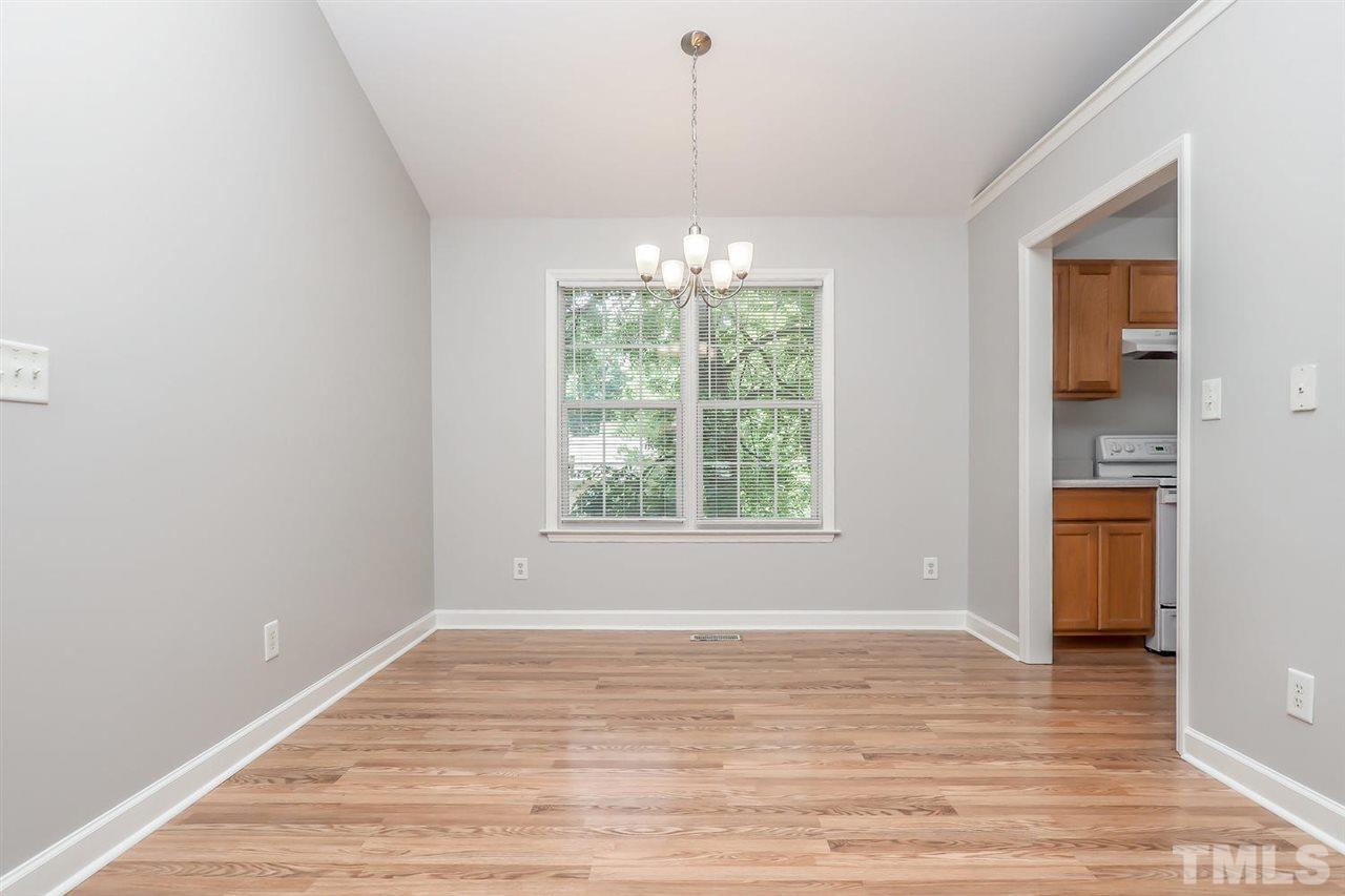 3121 Stedman Drive Raleigh, NC 27607 - Photo 5 of 25 a view of an empty room with wooden floor and a window