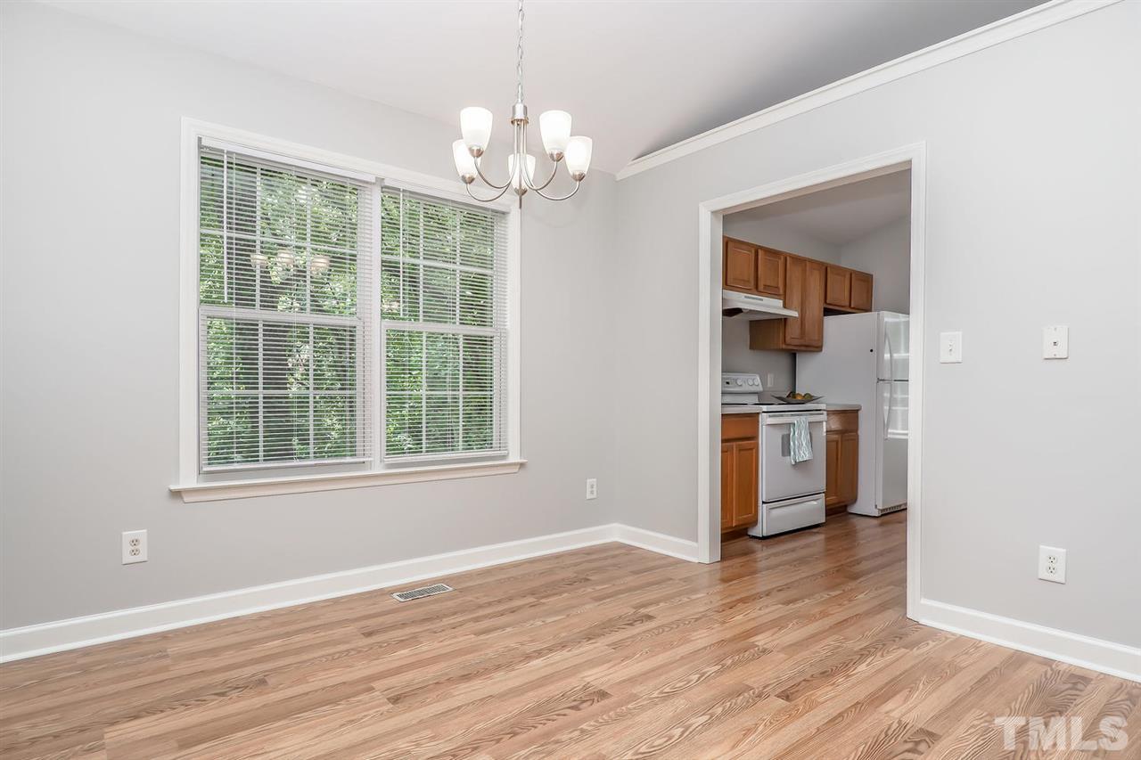 3121 Stedman Drive Raleigh, NC 27607 - Photo 6 of 25 a view of a room with wooden floor and lots of windows