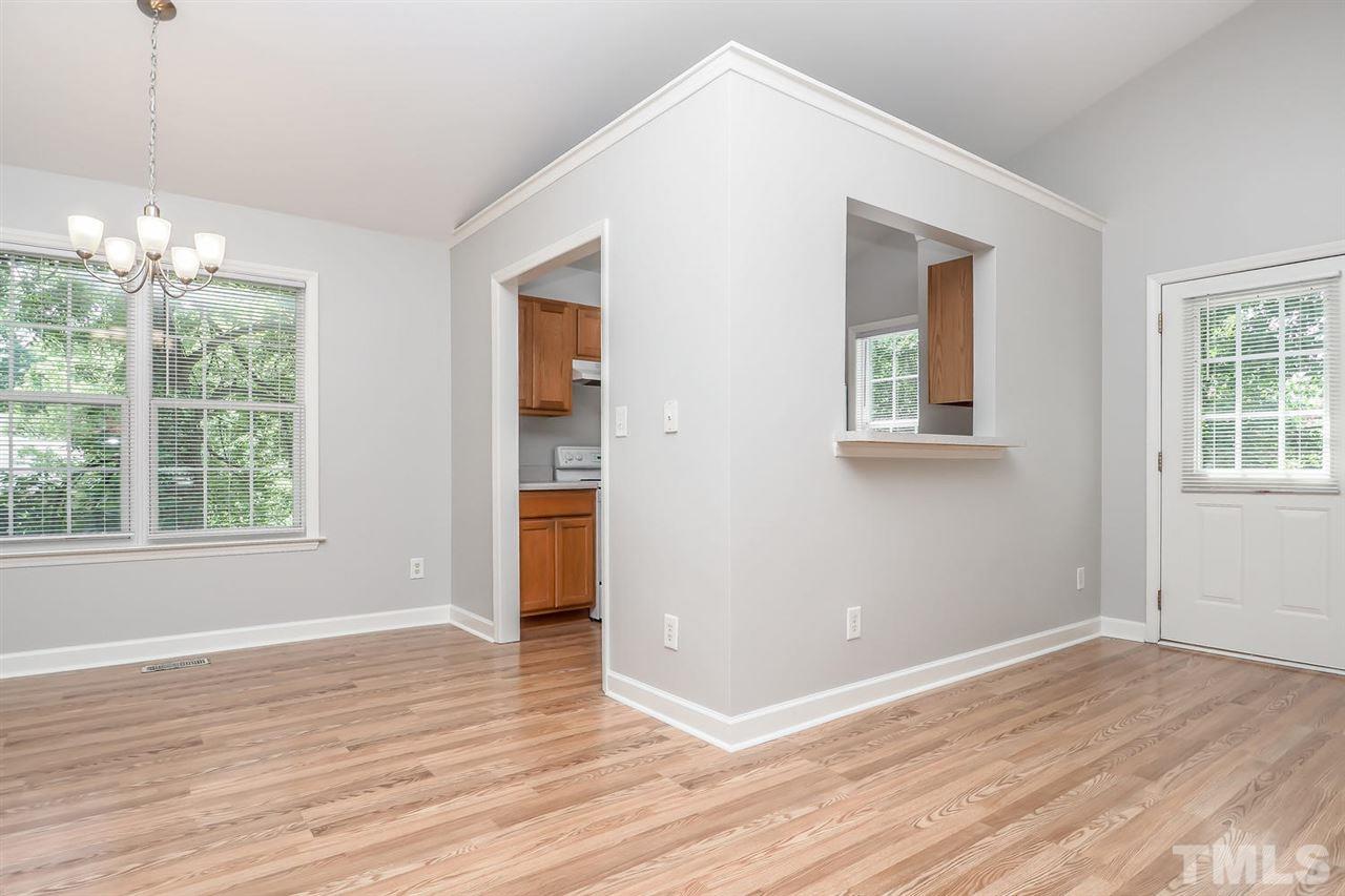 3121 Stedman Drive Raleigh, NC 27607 - Photo 7 of 25 a view of an empty room with wooden floor and a window