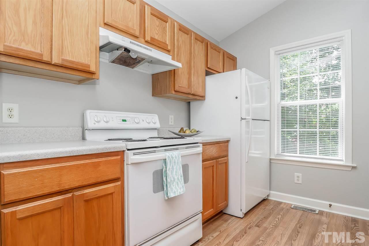 3121 Stedman Drive Raleigh, NC 27607 - Photo 9 of 25 a kitchen with stainless steel appliances granite countertop a sink a stove and a refrigerator