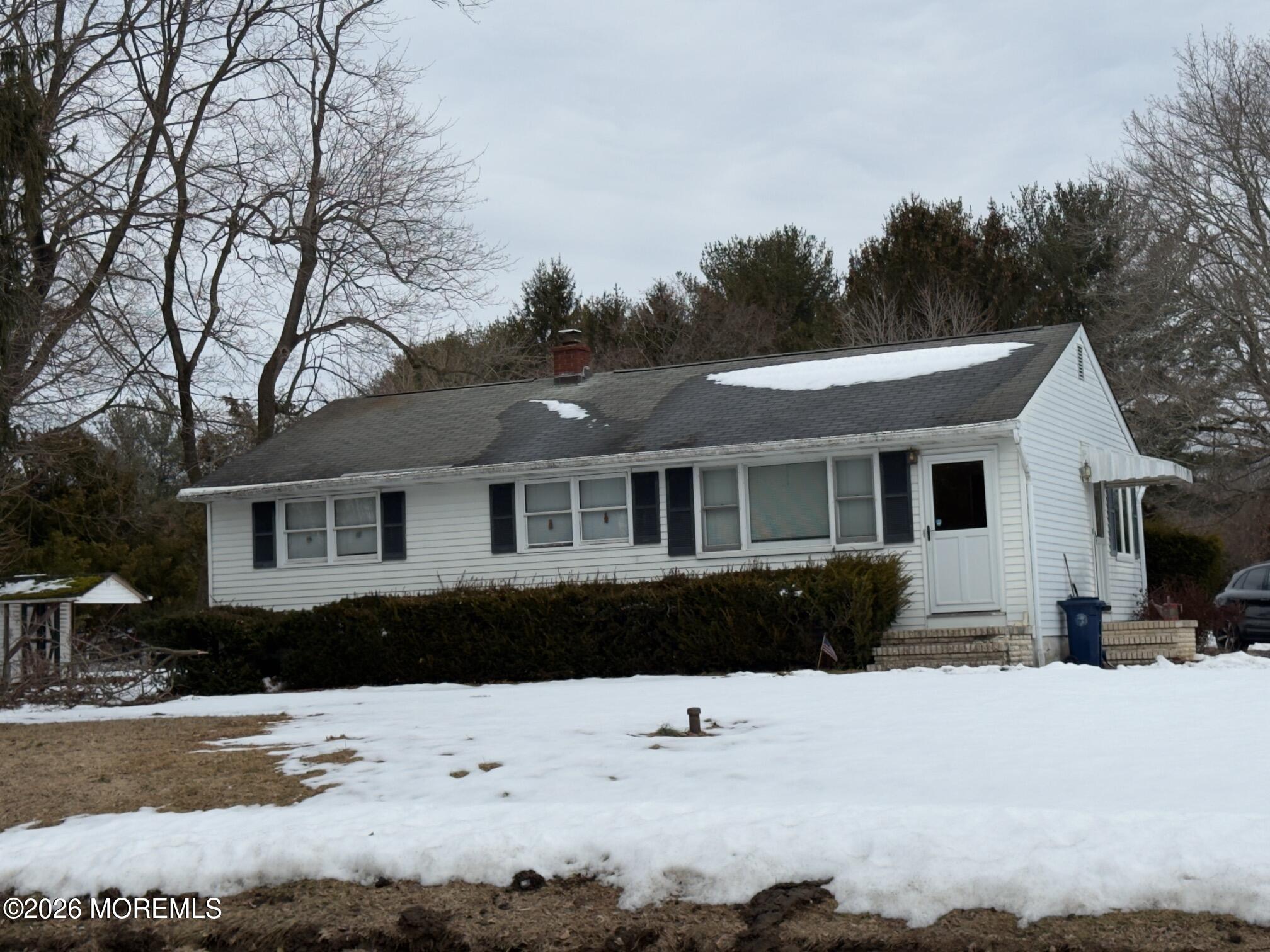 325 Sharon Road Hightstown, NJ 08520 - Photo 2 of 13 a front view of a house with a yard covered with snow