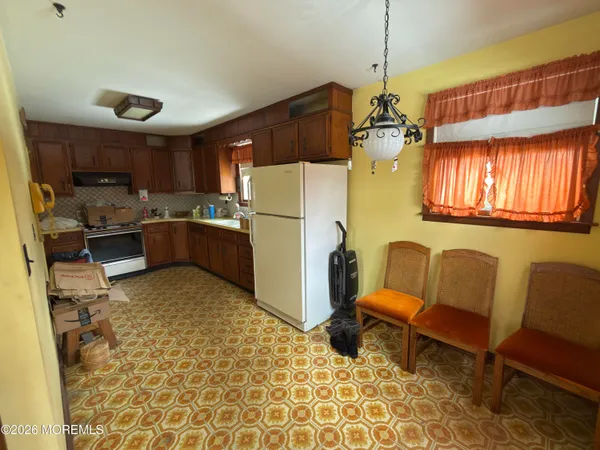 a kitchen with a refrigerator and a sink