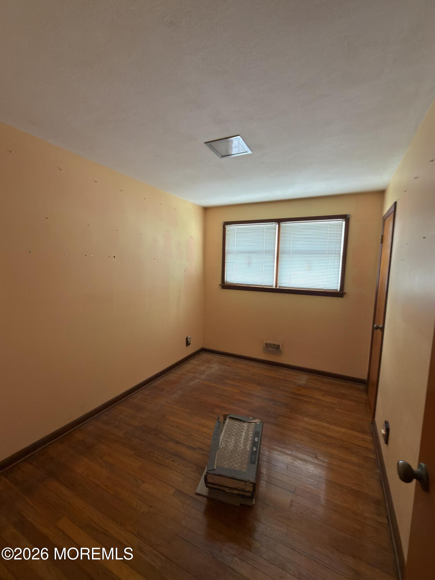 325 Sharon Road Hightstown, NJ 08520 - Photo 8 of 13 an empty room with wooden floor and windows