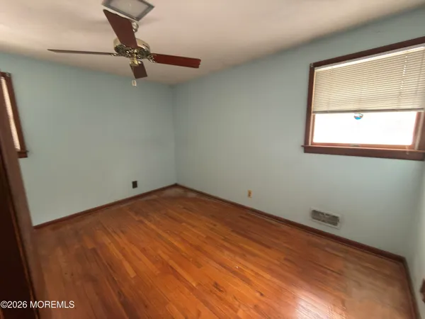 a view of a room with a window and ceiling fan