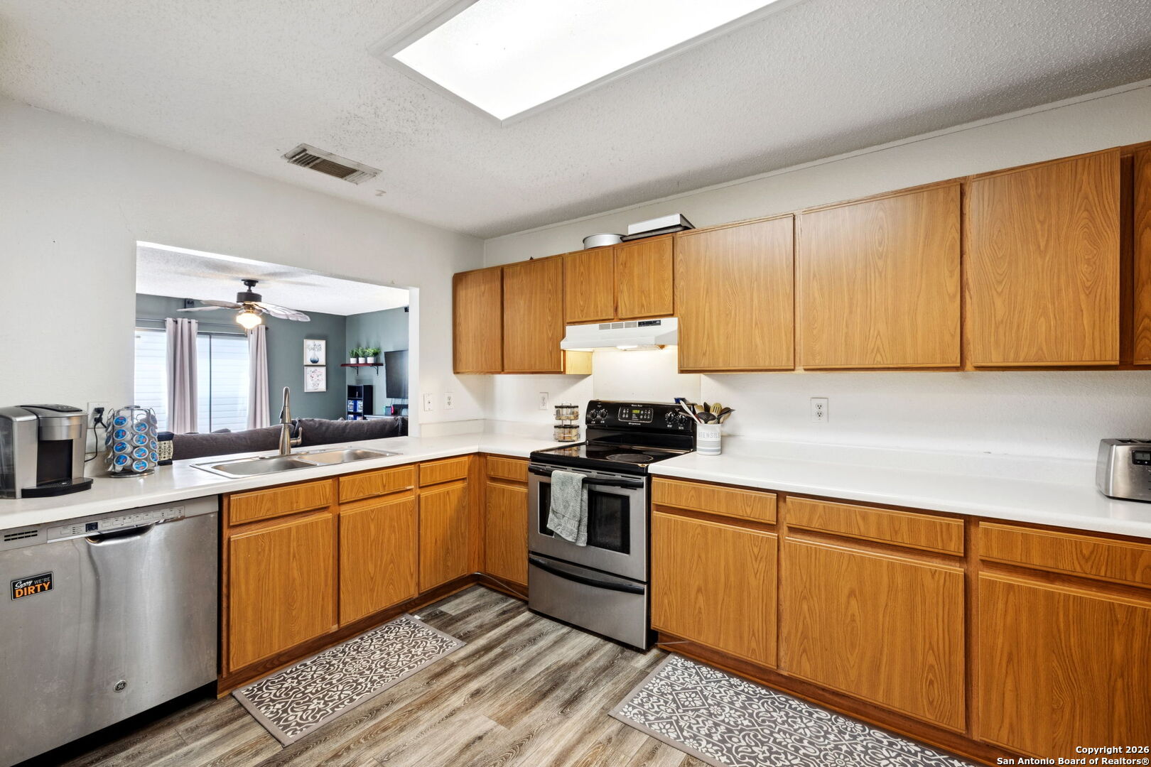 6622 Evenridge Lane San Antonio, TX 78239 - Photo 11 of 21 a kitchen with stainless steel appliances granite countertop a sink stove and refrigerator