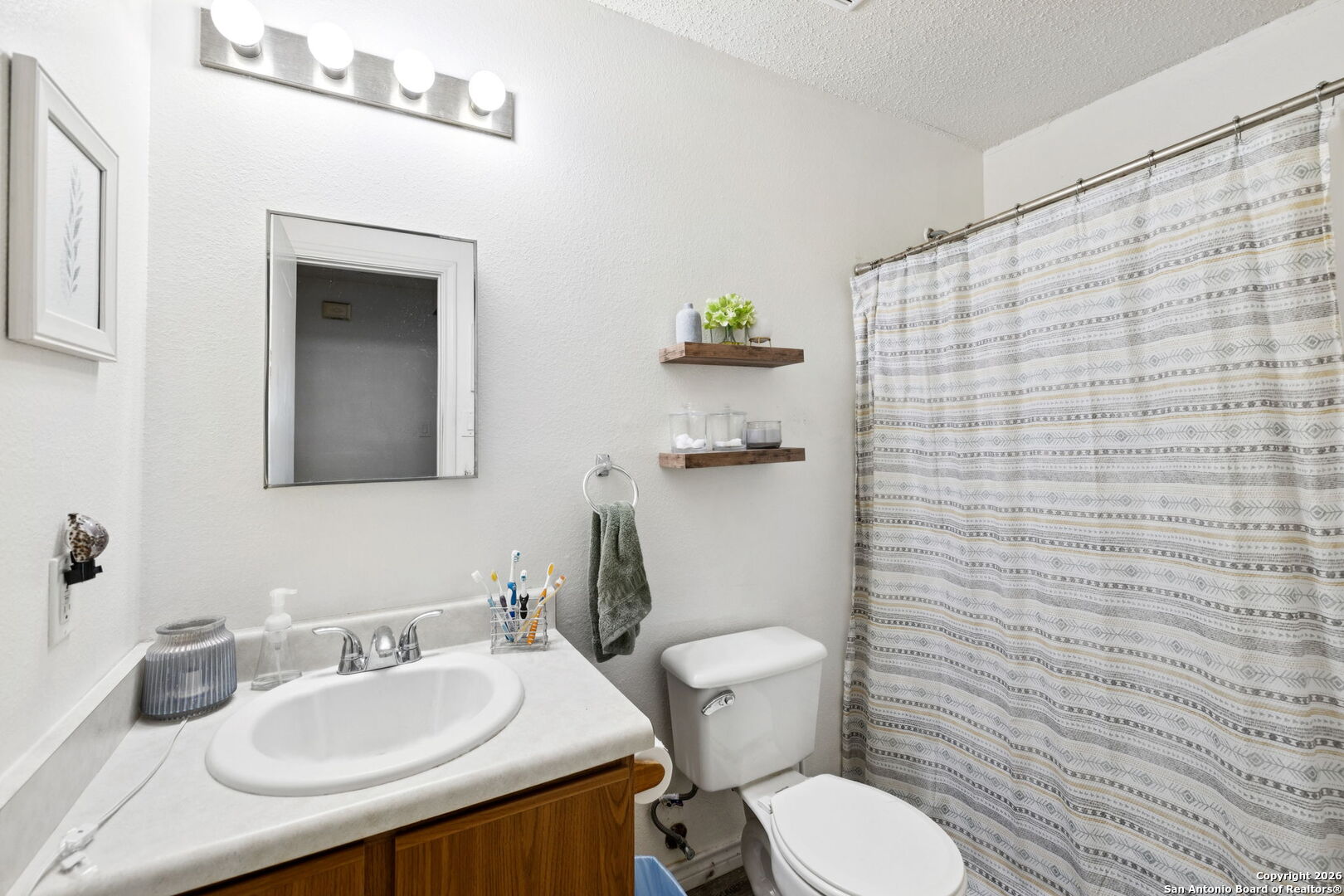 6622 Evenridge Lane San Antonio, TX 78239 - Photo 13 of 21 a bathroom with a sink a toilet and mirror