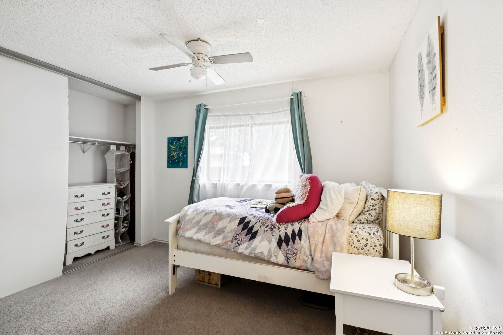 6622 Evenridge Lane San Antonio, TX 78239 - Photo 17 of 21 a bedroom with a bed and a lamp