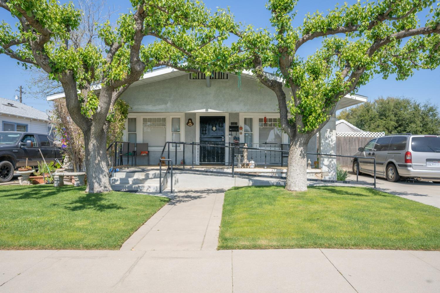 1164 J Street Reedley, CA 93654 - Photo 1 of 43 a house view with a sitting space and garden